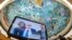 UN High Commissioner for Human Rights Volker Turk is seen on a TV monitor as the ceiling of the  Human Rights and Alliance of Civilizations Room, painted by Spanish painter Miquel Barcelo, is seen in the background at the opening of the 53rd UN Human Righ