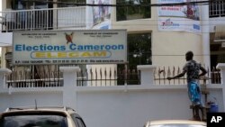 A man paints the electoral commission office in Yaounde, Cameroon, Oct. 10, 2018. 