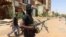 FILE — A member of the Sudanese Armed Forces, SAF, looks on as he holds his weapon in the street in Omdurman, on March 9, 2024. UNICEF says ongoing fighting between the nation's army and the RSF has led to death of thousands and is causing famine. 