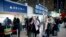 Passengers wait in front of the desk of American airline company 'Delta', at the Roissy Charles de Gaulle airport, north of Paris, Thursday, March 12, 2020.
