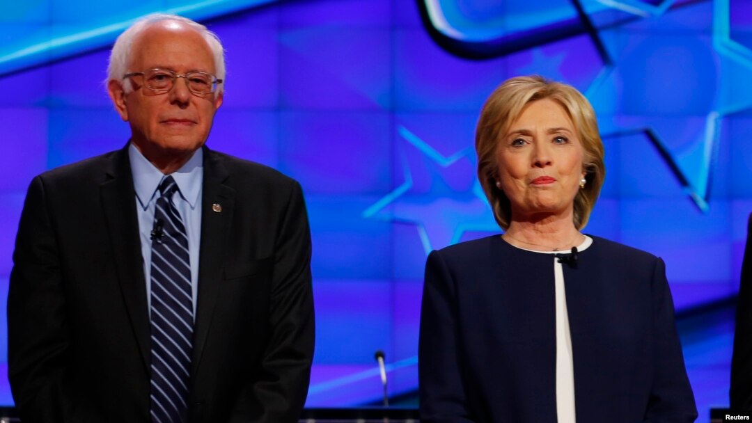 Democratic presidential candidate Senator Bernie Sanders and former Secretary of State Hillary Clinton stand together before the start of the first official Democratic candidates debate of the 2016 presidential campaign in Las Vegas, Nevada Oct. 13, 2015.