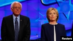 Democratic presidential candidate Senator Bernie Sanders and former Secretary of State Hillary Clinton stand together before the start of the first official Democratic candidates debate of the 2016 presidential campaign in Las Vegas, Nevada Oct. 13, 2015.