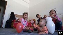 Displaced children play in a room in a school, where they are living with their family, who fled after a Saudi-led airstrike destroyed their houses, in Sana'a, Yemen, May 14, 2015.