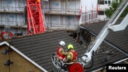 Rescue personnel work at the area where a crane collapsed in Bow, east London, Britain, July 8, 2020. 