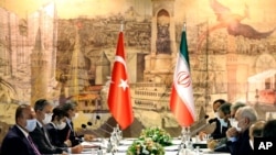 FILE - A Turkish delegation, left, meets with Iranian counterparts to discuss bilateral issues and Syria, June 15, 2020, in Istanbul. 