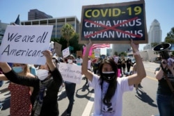FILE - Protesters march at a rally against Asian hate crimes, near the Los Angeles Federal Building in downtown Los Angeles, March 27, 2021.