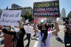 FILE - Protesters march at a rally against Asian hate crimes past the Los Angeles Federal Building in downtown Los Angeles, March 27, 2021.