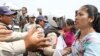 FILE - Yang Sophoan, director of the Cambodia Alliance of Trade Unions, clashes with the security police during a protest joined by over 100 members of labor unions in front of National Assembly, April 4, 2016. 