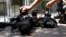 FILE - Photojournalists place their cameras on the ground during a demonstration in Mexico City condemning the alleged murder of fellow journalist Regina Martinez, a correspondent for investigative magazine and other media, April 29, 2012.