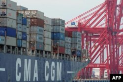 FILE - A ship loaded with containers ready for departure is seen berthed at the Chinese-majority owned Colombo International Container Terminal (CICT) in Colombo on March 30, 2016.