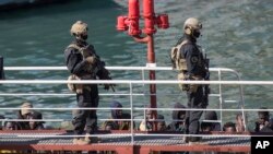 Armed forces stand on board the Turkish oil tanker El Hiblu 1, which was hijacked by migrants, in Valletta, Malta, March 28, 2019. A Maltese special operations team boarded the tanker Thursday and took control of it before escorting it to a Maltese port.