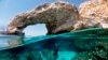 Cypriot marine ecologist Louis Hadjioannou dives to photograph the coral as he monitors the impact of climate change in the crystal clear waters of Glyko Nero in Ayia Napa, off the island&#39;s southeastern shore, Cyprus.