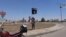 FILE - An image taken from a video uploaded on May 18, 2015 by Aamaq News Agency, a Youtube channel which posts videos from areas under the Islamic State (IS) group's control, allegedly shows an IS fighter hanging a flag of the group in a street of Ramadi.