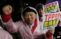 FILE - A protester shouts slogans during a rally against the Trans-Pacific Partnership (TPP) in Tokyo, April 22, 2014.