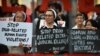 FILE - Catholic nuns hold placards as they protest against what organizers say are drug-related extrajudicial killings, during International Human Rights Day in Manila, Philippines, Dec. 10, 2016. 