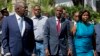 FILE - Haiti's President Jovenel Moise, center, walks with first lady Martine Moise and his Defense Minister Herve Denis, left, during a ceremony presenting the leadership of the newly reinstated Haitian Armed Forces (FAd'h) in Port-au-Prince, Haiti.