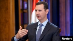 Syria's President Bashar al-Assad speaks during an interview with Fox News channel in Damascus, Sept. 19, 2013.