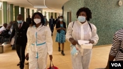 Netsai Marova (C) and Cecilia Chimbiri (R) arrive at Harare Magistrates Court, March 6, 2021, with Charles Kwaramba (L) of Zimbabwe Lawyers for Human Rights. (Columbus Mavhunga/VOA) 