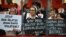 FILE - Catholic nuns hold placards as they protest against what organizers say are drug-related extrajudicial killings, during International Human Rights Day in Manila, Philippines, Dec. 10, 2016. 