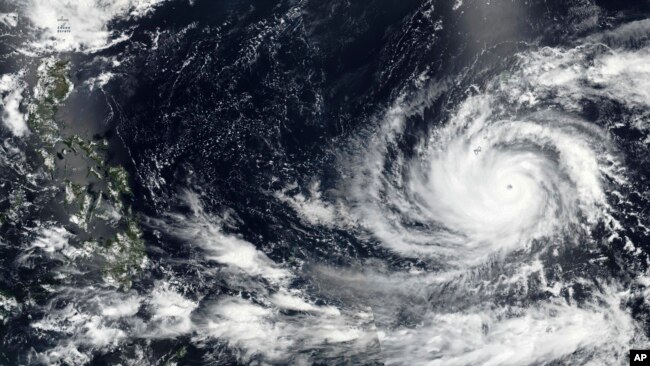 This May 23, 2023 satellite image released by NASA shows Typhoon Mawar, a powerful storm that could deliver the biggest hit in two decades to the U.S. territory in the Pacific, approaching Guam.