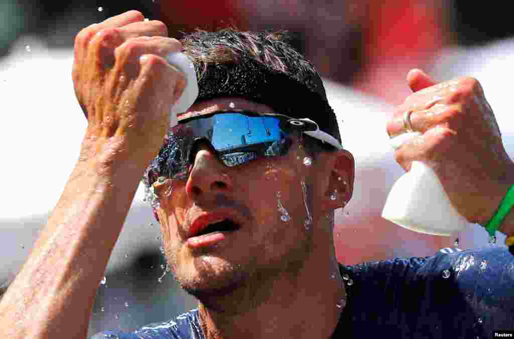 Triathlete Jan Frodeno of Germany tries to cool down on his way to win the Ironman triathlon European Championships in Frankfurt, Germany.