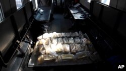 FILE - Gold bars sit inside a military plane before being taken to Venezuela's Central Bank, at Carlota military airport in Caracas, Venezuela, March 1, 2018.