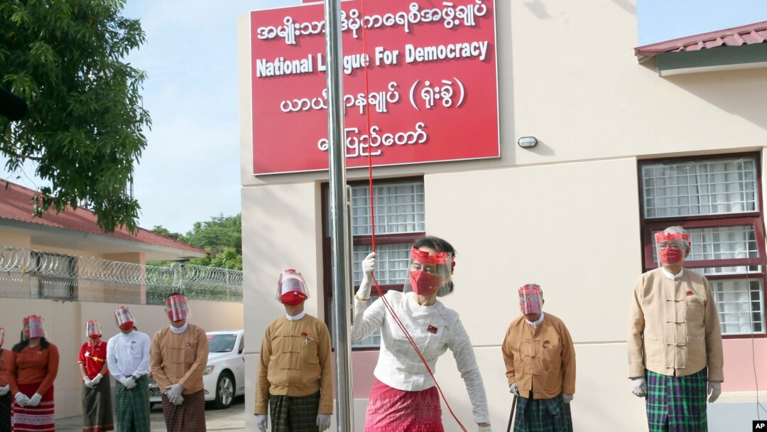 Pemimpin Myanmar Aung San Suu Kyi mengibarkan bendera partai Liga Nasional Untuk Demokrasi dalam upacara untuk menandai hari pertama kampanye pemilu di markas sementara partai di Naypyitaw, Myanmar pada Selasa, 8 September 2020. (Foto: AP)