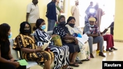 FILE - People wait after receiving the AstraZeneca's COVID-19 vaccine at the National Hospital in Abuja, Nigeria, March 31, 2021.