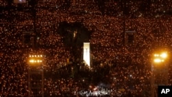 FILE - Thousands of people attend a candlelight vigil for victims of the Chinese government's brutal military crackdown three decades ago on protesters in Beijing's Tiananmen Square at Victoria Park in Hong Kong, June 4, 2019.