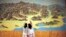 FILE - People point to a map on a wall in Mount Kumgang resort in Kumgang, Sept. 1, 2011. 