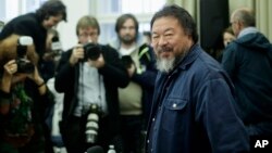 FILE - Chinese artist and dissident Ai Weiwei arrives for a news conference in Berlin, Oct. 26, 2015. 