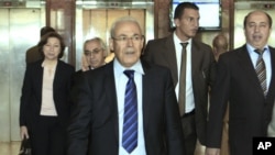 Leader of the opposition of the Syrian National Council, Burhan Ghalioun, center, and other members leave a meeting with Egyptian Foreign Minister Mohamed Kamel Amr in Cairo, Egypt, April 23, 2012.