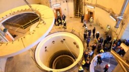FILE - In this photo released by the Atomic Energy Organization of Iran, technicians work at the Arak heavy water reactor's secondary circuit, as officials and media visit the site, near Arak, Iran, Dec. 23, 2019. 