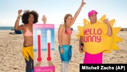 On a Fort Lauderdale beach in Florida, Mr. Sunny, with bikini models, gives away prizes and trip getaways for people in colder places like Boston, February 2015. (Photo by Mitchell Zachs/AP Images)