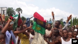 ** FILE ** Supporters of the Movement for the Actualization of the Sovereign State of Biafra, MASSOB, protest in the streets of Aba, eastern Nigeria, Dec. 5 2005. MASSOB has struck chords among many Igbo.