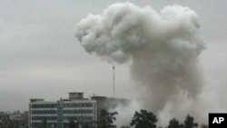 Dust and smoke rise after an explosion in Kandahar, Afghanistan, Feb 12, 2011