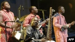 FILE - Toumani Diabaté, center, of Mali plays on his kora, an African harp, in Budapest, Aug. 11, 2006.