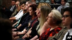 A row is filled with family members who lost loved ones on the accidents aboard the USS McCain and USS Fitzgerald, during a Senate Armed Services Committee hearing, Sept. 19, 2017, on Capitol Hill in Washington. 