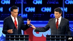 Republican presidential candidates former Massachusetts Gov. Mitt Romney, left, and Texas Gov. Rick Perry gesture during a Republican debate Monday, Sept. 12, 2011, in Tampa, Fla.