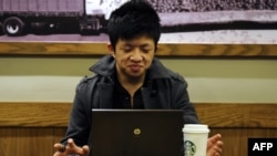 People often hang out over a cup of coffee or work. This man uses his computer in a coffee shop in Shanghai, China. (File photo)