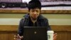 A man uses his computer in a coffee shop in Shanghai, (File photo).