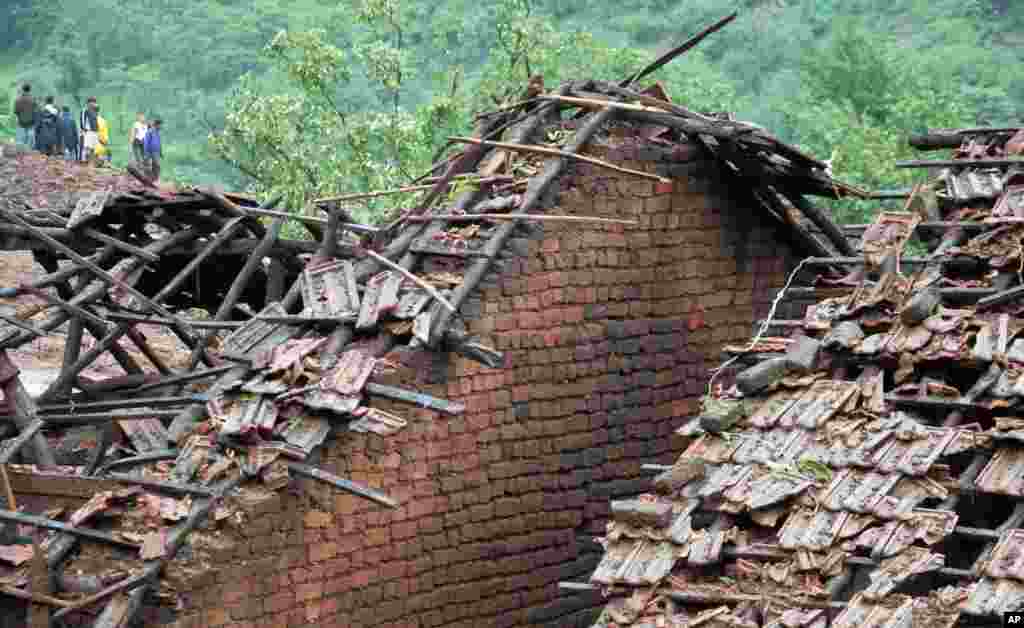 Damaged homes in Malin village, Wednesday, July 30, 2014.