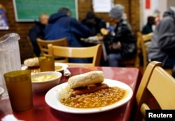 FILE - A meal is served in a New York City soup kitchen.