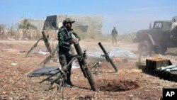 In this photo released by the Syrian official news agency SANA, Syrian army soldiers prepare to launch a mortar towards insurgents in the village of Kfar Nabuda, in the countryside of Syria's Hama province, May 11, 2019.