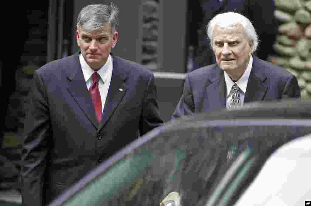 Billy Graham, right, and his son Franklin Graham, left, leave after a memorial service for Billy Graham's wife, Ruth Graham, in Montreat, N.C., June 16, 2007. 