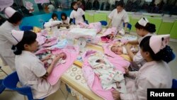 Infants undergo a daily medical examination at a maternal and child health care hospital in Taiyuan. Experts say China's new two-child policy could spur economy because more child-related service will be needed.
