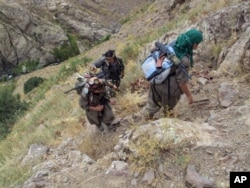 FILE - Rebels of the Kurdistan Workers Party [PKK] are seen in Turkey near the border with Iraq, May 2013.