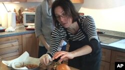 Food stylist Lisa Cherkasky preps a sandwich during a photo shoot.