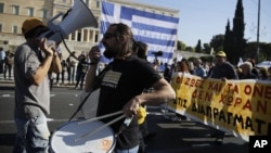 Part of a 24-hour nationwide strike, demonstrators protest against the government's austerity policies outside the Greek Parliament in Athens, Nov. 12, 2015.