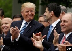 President Donald Trump talks with House Speaker Paul Ryan of Wis., in the Rose Garden of the White House in Washington, May 4, 2017, after the House pushed through a health care bill.